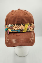 Load image into Gallery viewer, Handmade distressed brown baseball cap featuring embroidered floral appliqués, colorful boho trim, lace accents, and decorative leaf charm