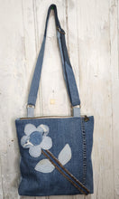 Load image into Gallery viewer, Shop this one-of-a-kind handmade upcycled denim tote bag featuring a floral appliqué design, adjustable strap, and zippered closure. Sustainable, stylish, and perfect for everyday use.
