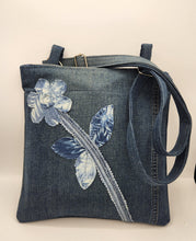 Load image into Gallery viewer, upcycled denim bag, handmade crossbody purse, floral appliqué shoulder bag, eco friendly tote, recycled jeans bag, boho denim handbag, sustainable fashion accessory, handmade shoulder bag, unique denim purse, artisan fabric bag, repurposed fabric crossbody
