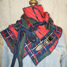 Load image into Gallery viewer, A handmade plaid scarf or shawl made from mixed denim and tweed fabrics in red, navy, green, and blue, styled on a denim jacket mannequin torso with a leather strap accessory.
