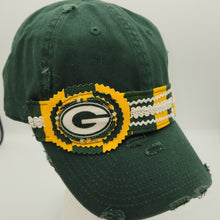Load image into Gallery viewer, A distressed green baseball cap with a Green Bay Packers themed woven headband featuring a large 'G' logo patch, displayed on a white mannequin head against a white background.
