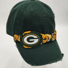 Load image into Gallery viewer, A dark green distressed baseball cap featuring a Green Bay Packers themed bandana-style headband with a central Packers logo patch, displayed on a white mannequin head against a light gray background.
