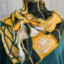 Load image into Gallery viewer, A green and yellow rag-textured knit scarf with 'Packers Football' embroidery, draped on a mannequin torso wearing a green sweatshirt.

